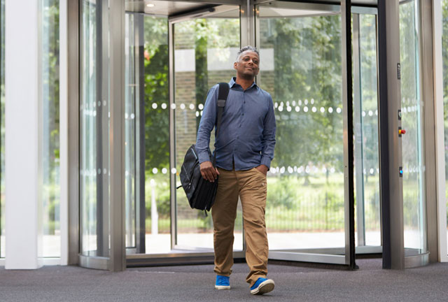 Person walking from some revolving doors