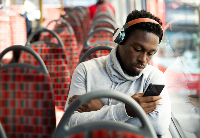 Person looking at their phone on public transport